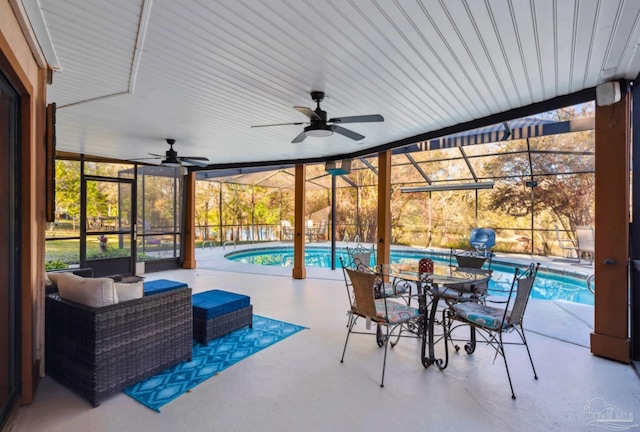 view of patio / terrace featuring ceiling fan, outdoor dining space, a lanai, and an outdoor pool