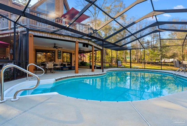 outdoor pool featuring a ceiling fan, glass enclosure, an outdoor living space, and a patio area