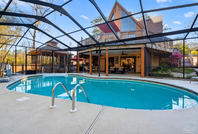 outdoor pool with a patio, an outdoor living space, ceiling fan, and a lanai