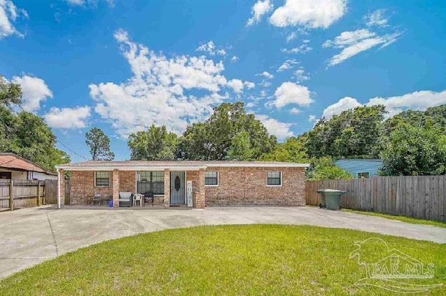 back of property featuring a patio and a lawn