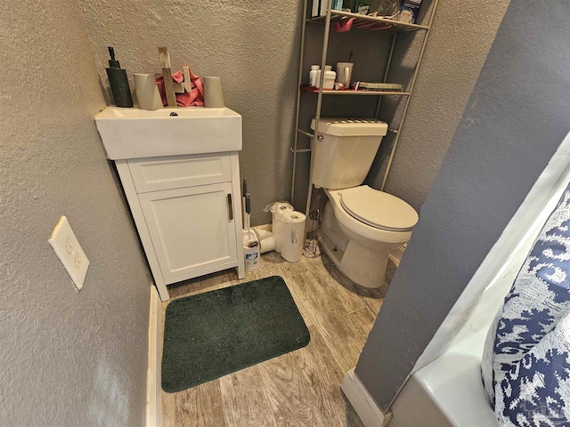 bathroom featuring hardwood / wood-style flooring, vanity, and toilet