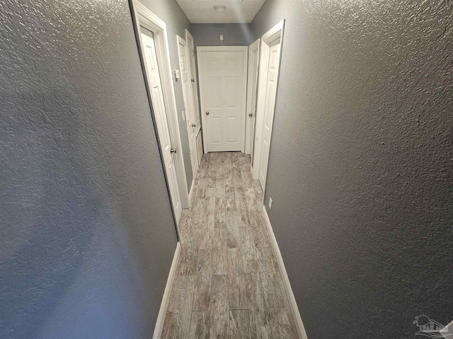 corridor featuring light hardwood / wood-style floors