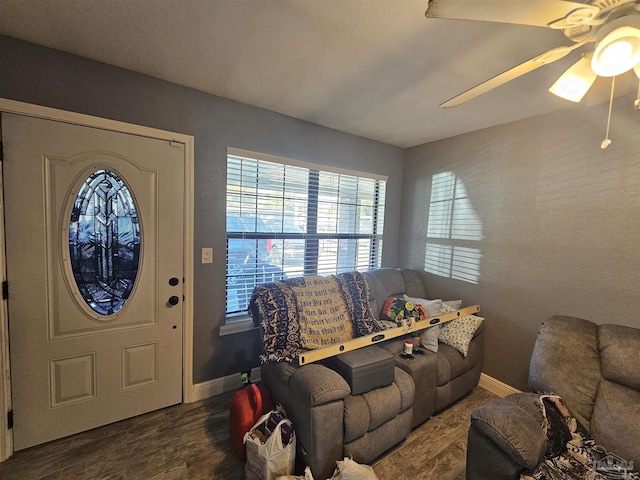 living room with dark hardwood / wood-style flooring and ceiling fan