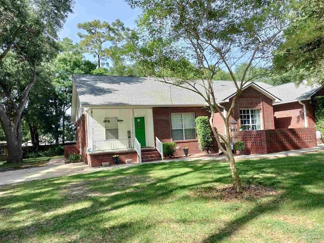 10800 Beulah Rd Unit A & B, Pensacola, FL 32526 - view of front of property with brick siding, a porch, a front lawn, and a shingled roof