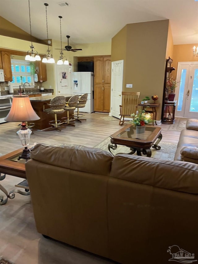 10800 Beulah Rd Unit A & B, Pensacola, FL 32526 - living area featuring vaulted ceiling, a chandelier, ceiling fan, light wood finished floors, and plenty of natural light