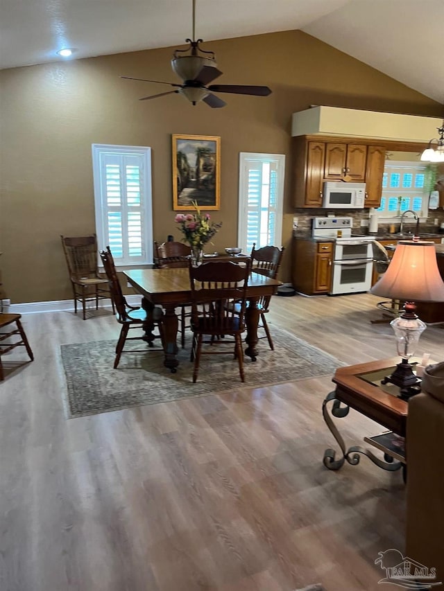 10800 Beulah Rd Unit A & B, Pensacola, FL 32526 - dining space featuring light wood-type flooring, vaulted ceiling, ceiling fan, and baseboards