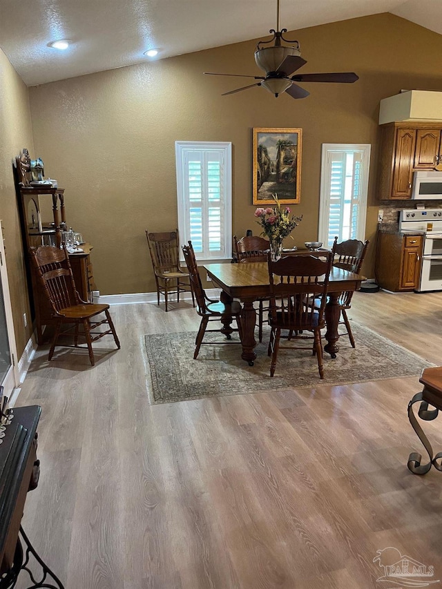 10800 Beulah Rd Unit A & B, Pensacola, FL 32526 - dining space with light wood finished floors, ceiling fan, vaulted ceiling, and baseboards