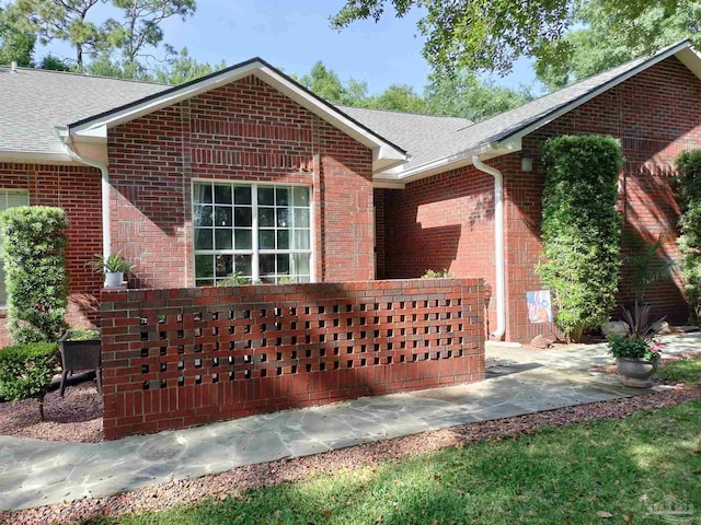 10800 Beulah Rd Unit A & B, Pensacola, FL 32526 - ranch-style home featuring brick siding, a shingled roof, and a patio area