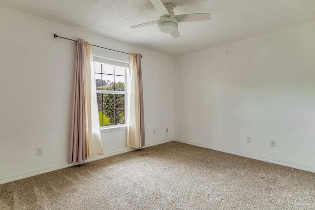 carpeted spare room featuring ceiling fan and a textured ceiling