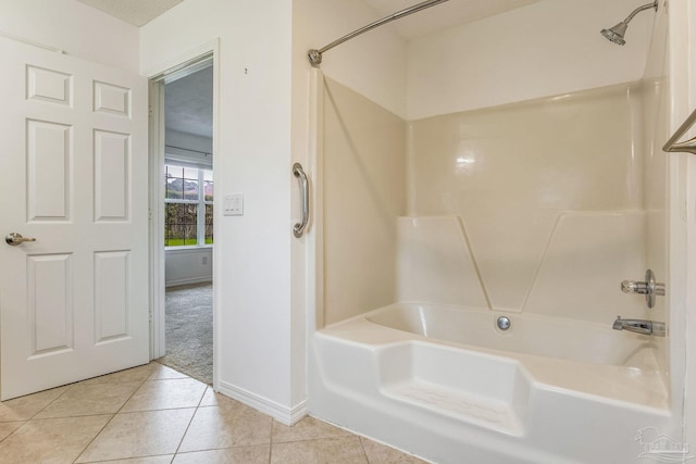 bathroom featuring a textured ceiling, tile patterned floors, and bathing tub / shower combination