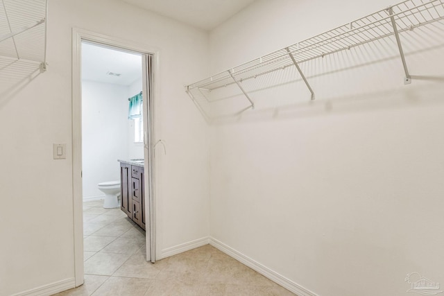 spacious closet featuring light tile patterned floors