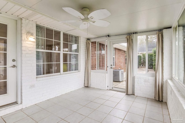 unfurnished sunroom with ceiling fan