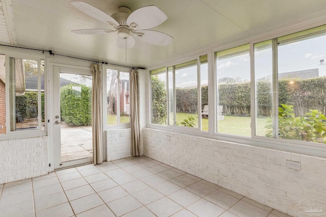 unfurnished sunroom featuring ceiling fan