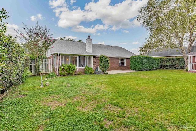 back of house with a lawn