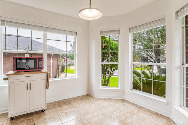 unfurnished dining area with light tile patterned floors