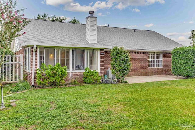 back of property featuring cooling unit, a yard, and a patio area