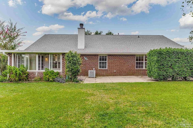 rear view of house featuring central air condition unit, a yard, and a patio area