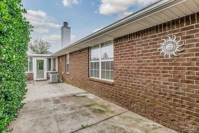 view of side of home with cooling unit and a patio area