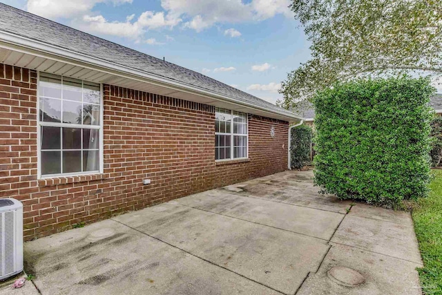 view of home's exterior with a patio area and central AC