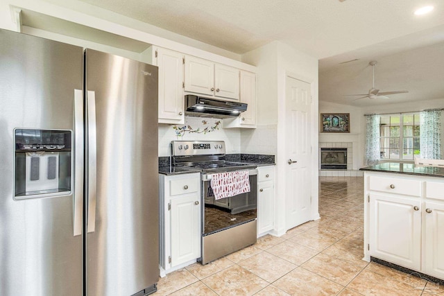 kitchen featuring white cabinetry, light tile patterned floors, a tile fireplace, ceiling fan, and appliances with stainless steel finishes