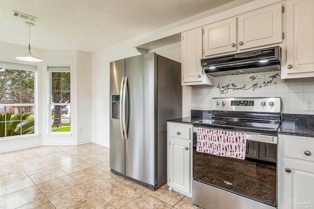 kitchen featuring stainless steel appliances, backsplash, and white cabinetry