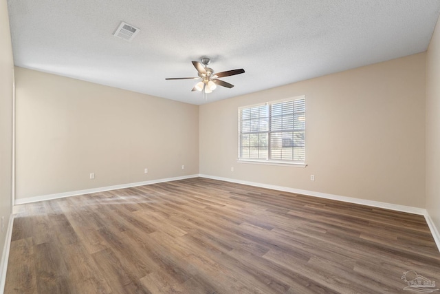 empty room featuring ceiling fan, a textured ceiling, and hardwood / wood-style floors