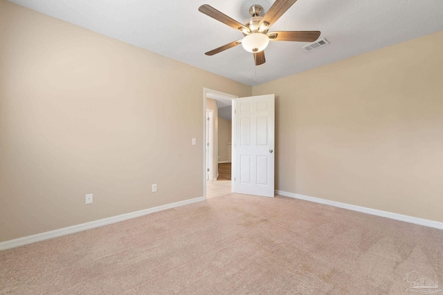 unfurnished room featuring light carpet and ceiling fan