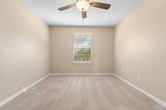 unfurnished room featuring light carpet, a textured ceiling, and ceiling fan