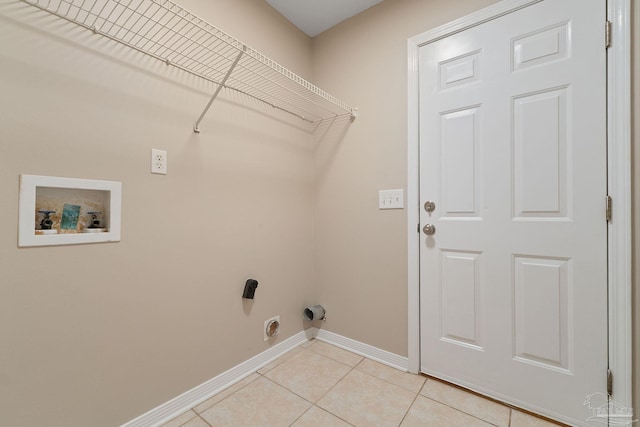 laundry room with hookup for an electric dryer, hookup for a washing machine, and light tile patterned floors