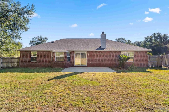 back of property featuring a patio area and a lawn