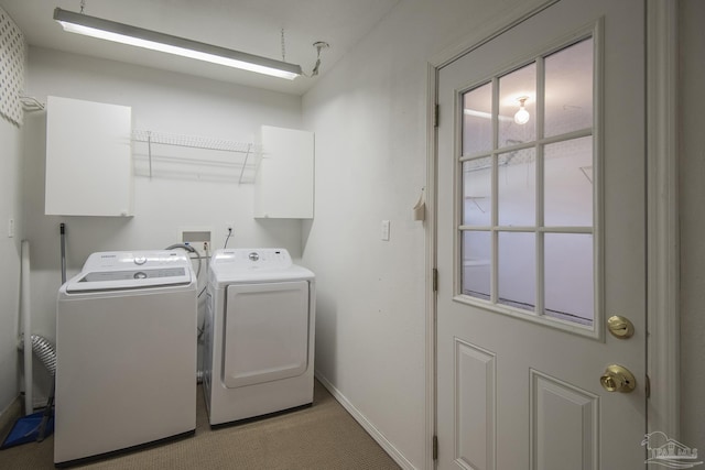 laundry area with baseboards, light colored carpet, and washing machine and clothes dryer