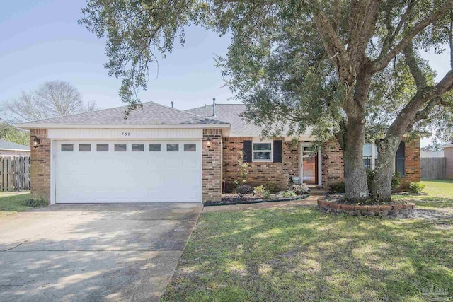 single story home featuring driveway, an attached garage, a front yard, and fence