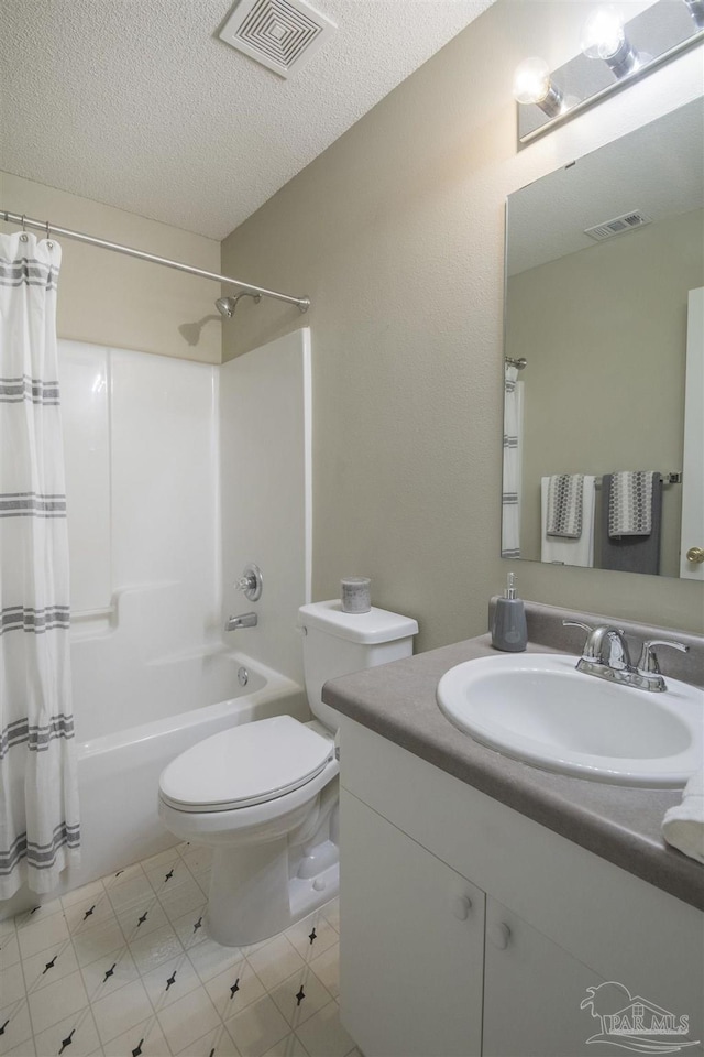 bathroom featuring visible vents, toilet, vanity, a textured ceiling, and shower / bathtub combination with curtain