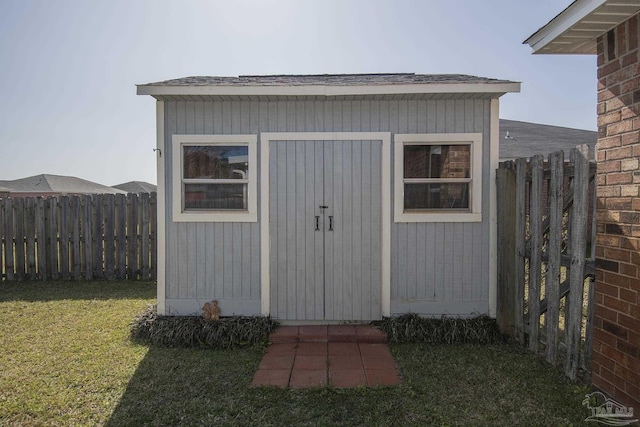 view of shed featuring fence