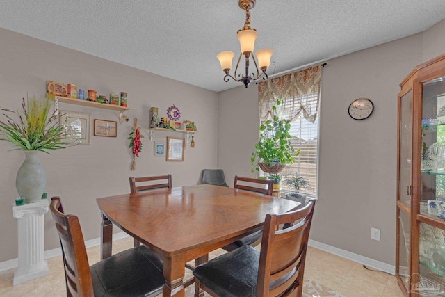 dining room with an inviting chandelier and a textured ceiling