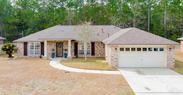 ranch-style house featuring a garage and a front lawn