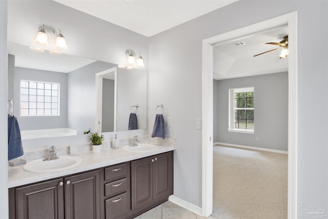 bathroom featuring vanity, ceiling fan, and a tub to relax in