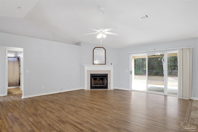 unfurnished living room with vaulted ceiling, dark wood-type flooring, ceiling fan, and a fireplace