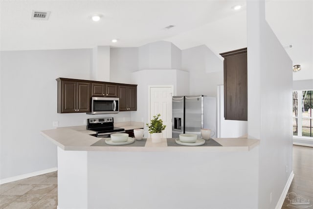 kitchen featuring high vaulted ceiling, dark brown cabinets, stainless steel appliances, and kitchen peninsula