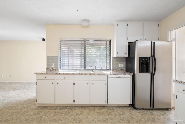 kitchen with a sink, white cabinetry, stainless steel refrigerator with ice dispenser, decorative backsplash, and dishwasher