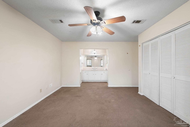 unfurnished bedroom featuring carpet floors, a closet, visible vents, and baseboards