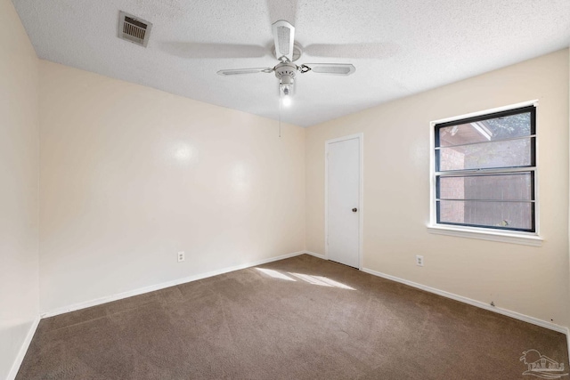 spare room with baseboards, visible vents, ceiling fan, a textured ceiling, and carpet flooring