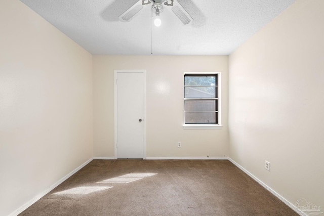 unfurnished room featuring carpet floors, baseboards, and a textured ceiling