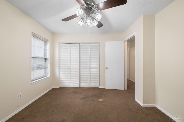 unfurnished bedroom with a ceiling fan, baseboards, a closet, and carpet flooring