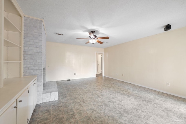 unfurnished living room featuring visible vents, a textured ceiling, a ceiling fan, and baseboards