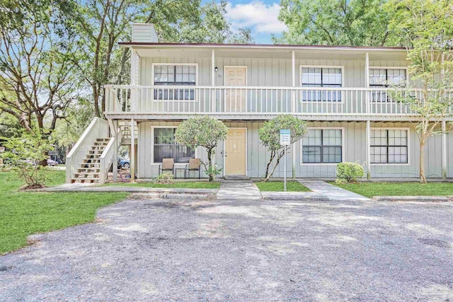 2811 Langley Ave Unit 221, Pensacola, FL 32504 - view of front of house featuring stairway, a chimney, and board and batten siding