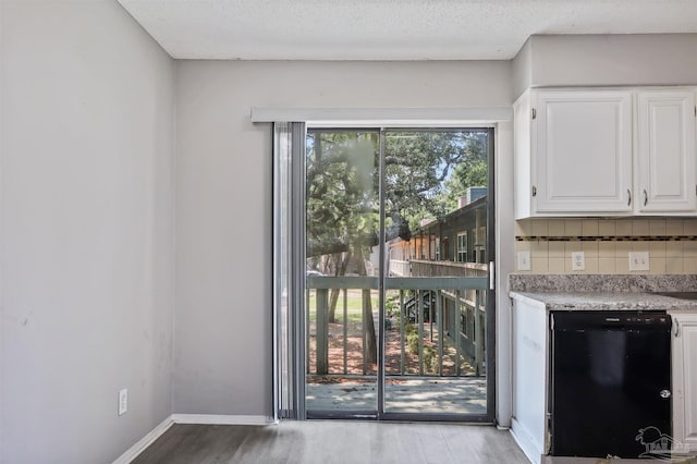 2811 Langley Ave Unit 221, Pensacola, FL 32504 - doorway with wood finished floors and baseboards