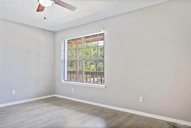 2811 Langley Ave Unit 221, Pensacola, FL 32504 - unfurnished room with a textured ceiling, baseboards, wood finished floors, and a ceiling fan