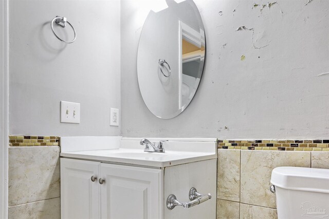 2811 Langley Ave Unit 221, Pensacola, FL 32504 - half bathroom with vanity, tile walls, and toilet