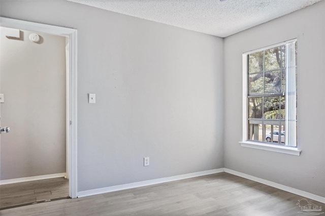 2811 Langley Ave Unit 221, Pensacola, FL 32504 - empty room with wood finished floors, a textured ceiling, baseboards, and a smoke detector
